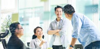 group of young asian business executives talking in office picture id1132890530