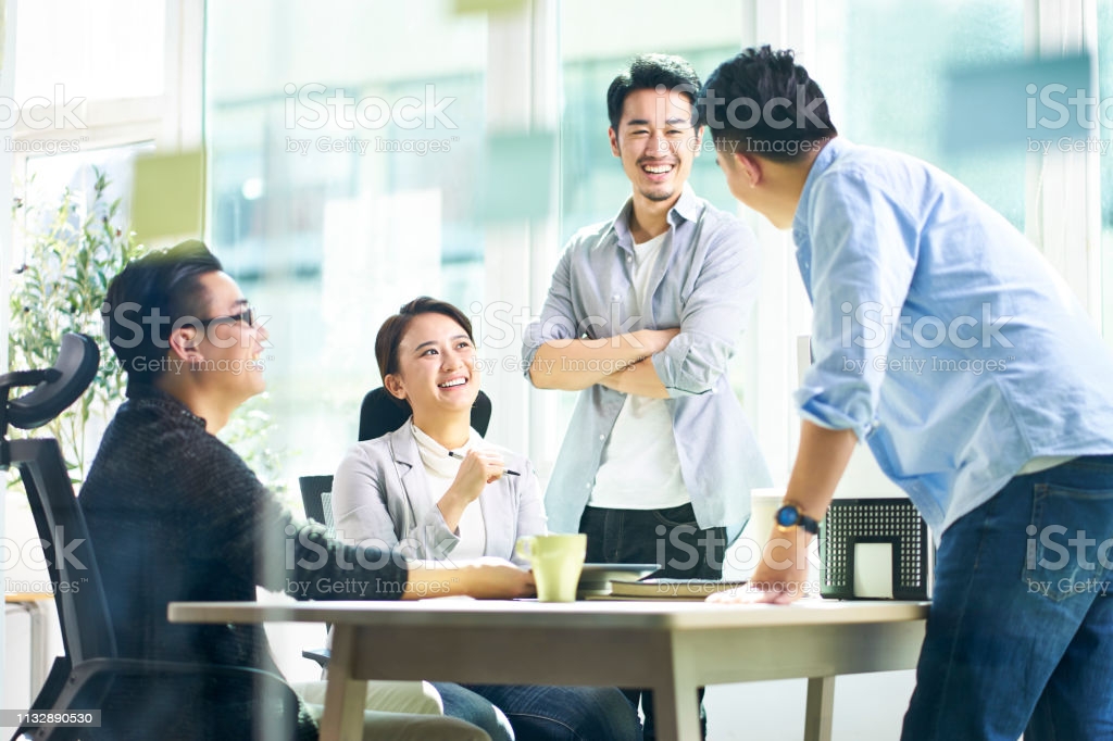 group of young asian business executives talking in office picture id1132890530