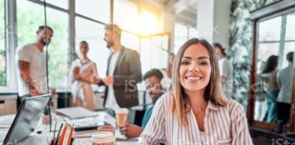 smiling female employee sit in coworking space and working on the picture id1283955441